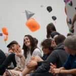 Group of people sitting on the floor at bouldering centre
