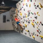 A man bouldering on a climbing wall in Easton.